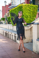 A black 1920s flapper dress with sleeves, black sequins, beads and fringes