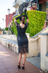 A black 1920s flapper dress with sleeves, black sequins, beads and fringes