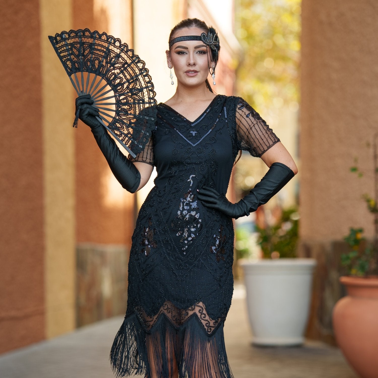 A black vintage 1920s dress with sleeves, black sequins, beads and fringes