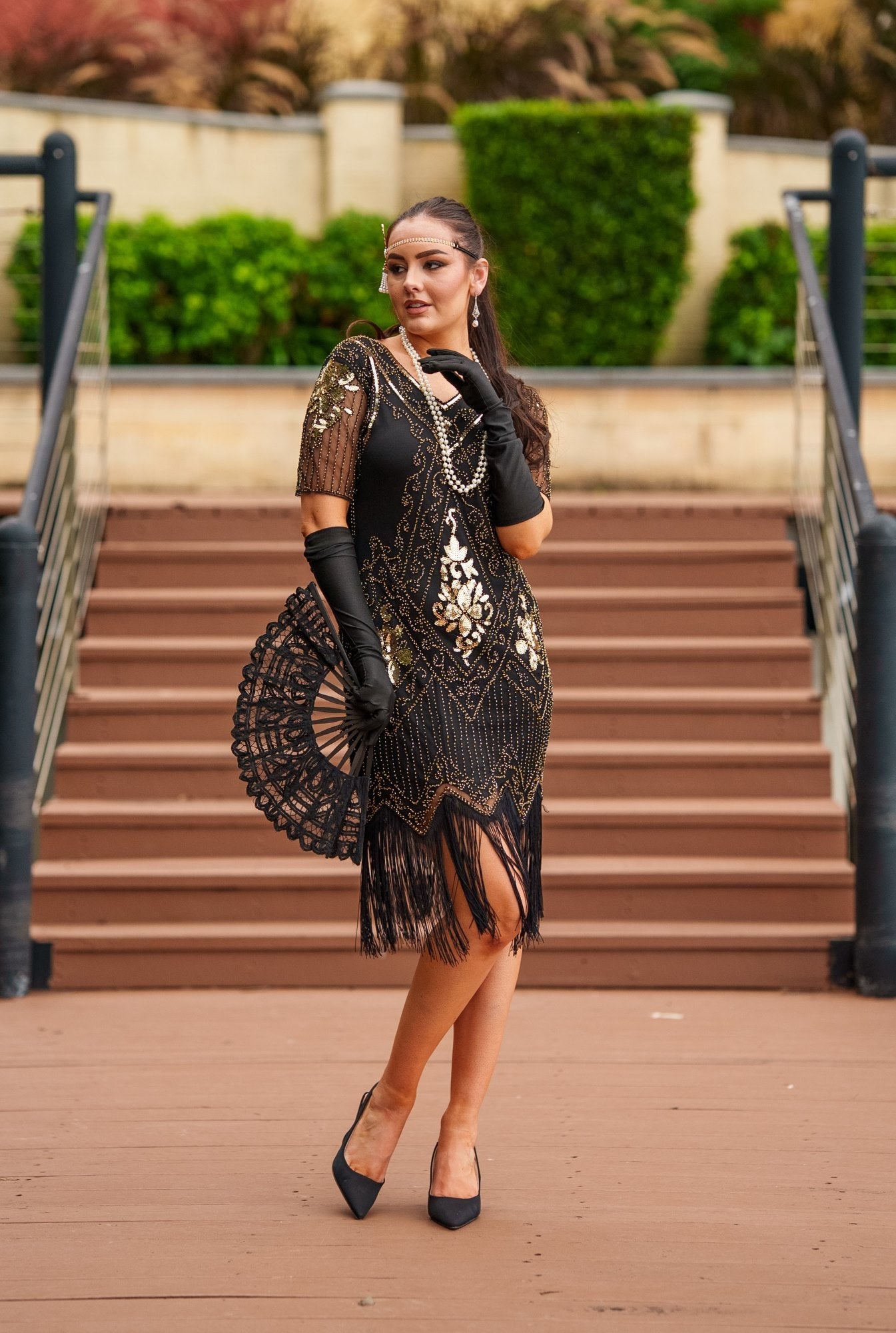 1920s Black and Gold Flapper Dress with sleeves – features sequins, beads, and fringe. Perfect for Gatsby parties