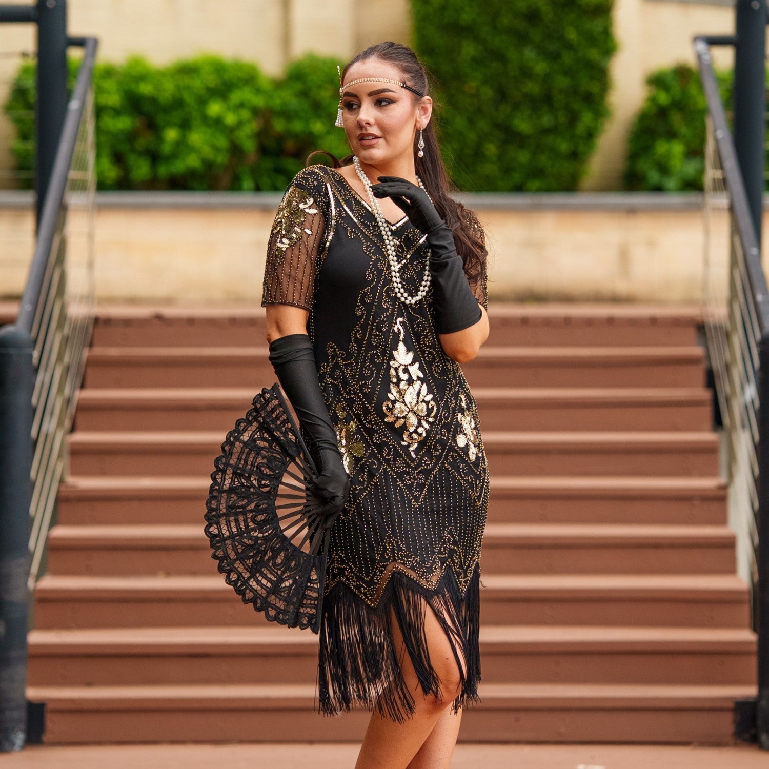 1920s Black and Gold Flapper Dress with sleeves – features sequins, beads, and fringe. Perfect for Gatsby parties