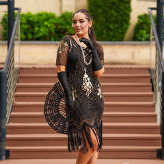1920s Black and Gold Flapper Dress with sleeves – features sequins, beads, and fringe. Perfect for Gatsby parties