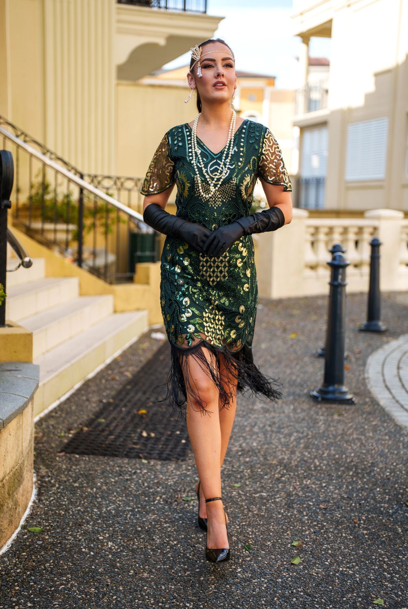 A Green 1920s Gatsby Dress with Sleeves, Green and Gold Sequins, Beads and Fringes around the Hem.
