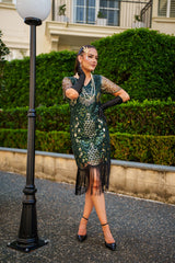 A Green 1920s Gatsby Dress with Sleeves, Green and Gold Sequins, Beads and Fringes around the Hem.
