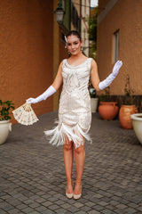 A white 1920s Flapper Dress with Gold Sequins, Beads and Fringe Details.
