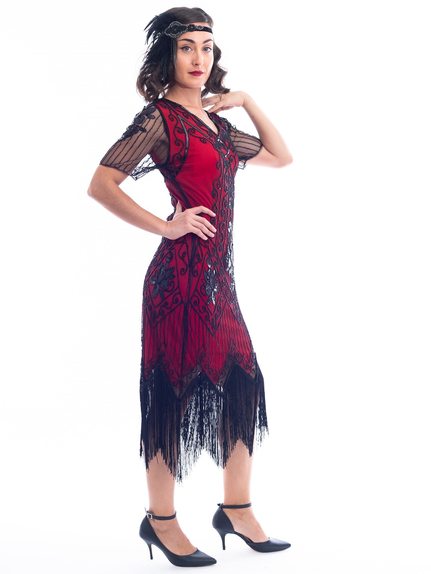 A side view of a burgundy red 1920s Flapper Dress with black beads, sequins, sheer sleeves and black fringes