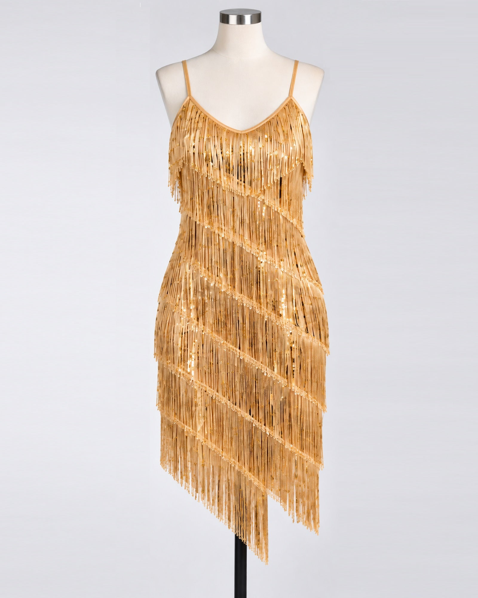 A gold fringe & sequin 1920s flapper dress displayed on a mannequin against a light gray studio background.