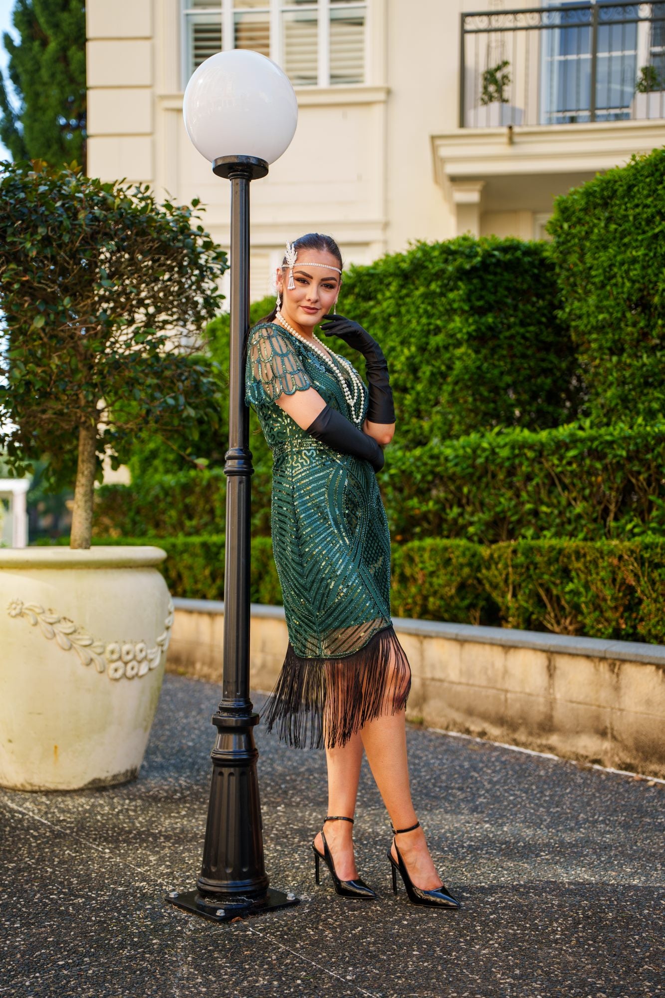 Side View of a 1920s Green Gatsby Dress with sequins, beads, sleeves and fringes. Perfect for Gatsby Parties