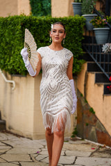 A stunning white 1920s flapper dress with sequins, beads and fringes around the hem. 
