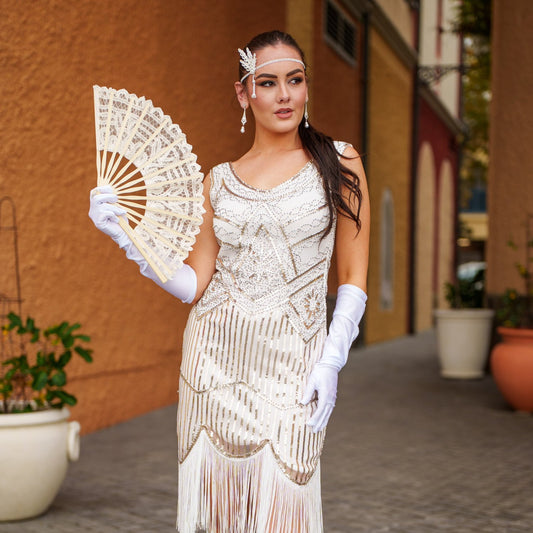 A white 1920s Flapper Dress with Gold Sequins, Beads and Fringe Details.