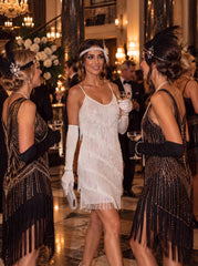 Lady wearing a a 1920s Style Cocktail Dress with white sequins and fringes. Talking to friends
