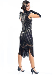 A black flapper dress with gold sequins and beads