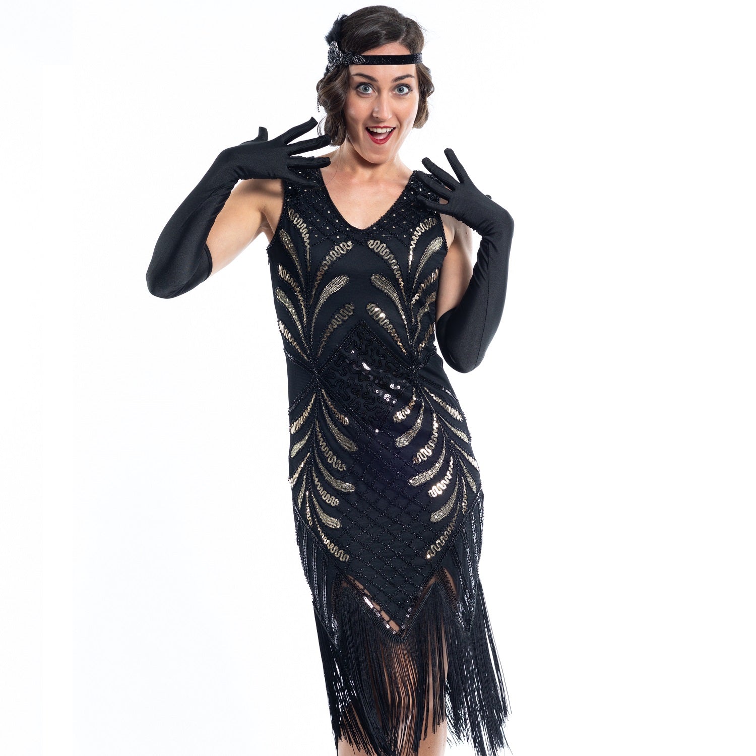 A black vintage flapper dress with black and gold sequins, gold beads and fringes around the hem - close view