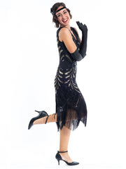 A black vintage flapper dress with black and gold sequins, gold beads and fringes around the hem - side view