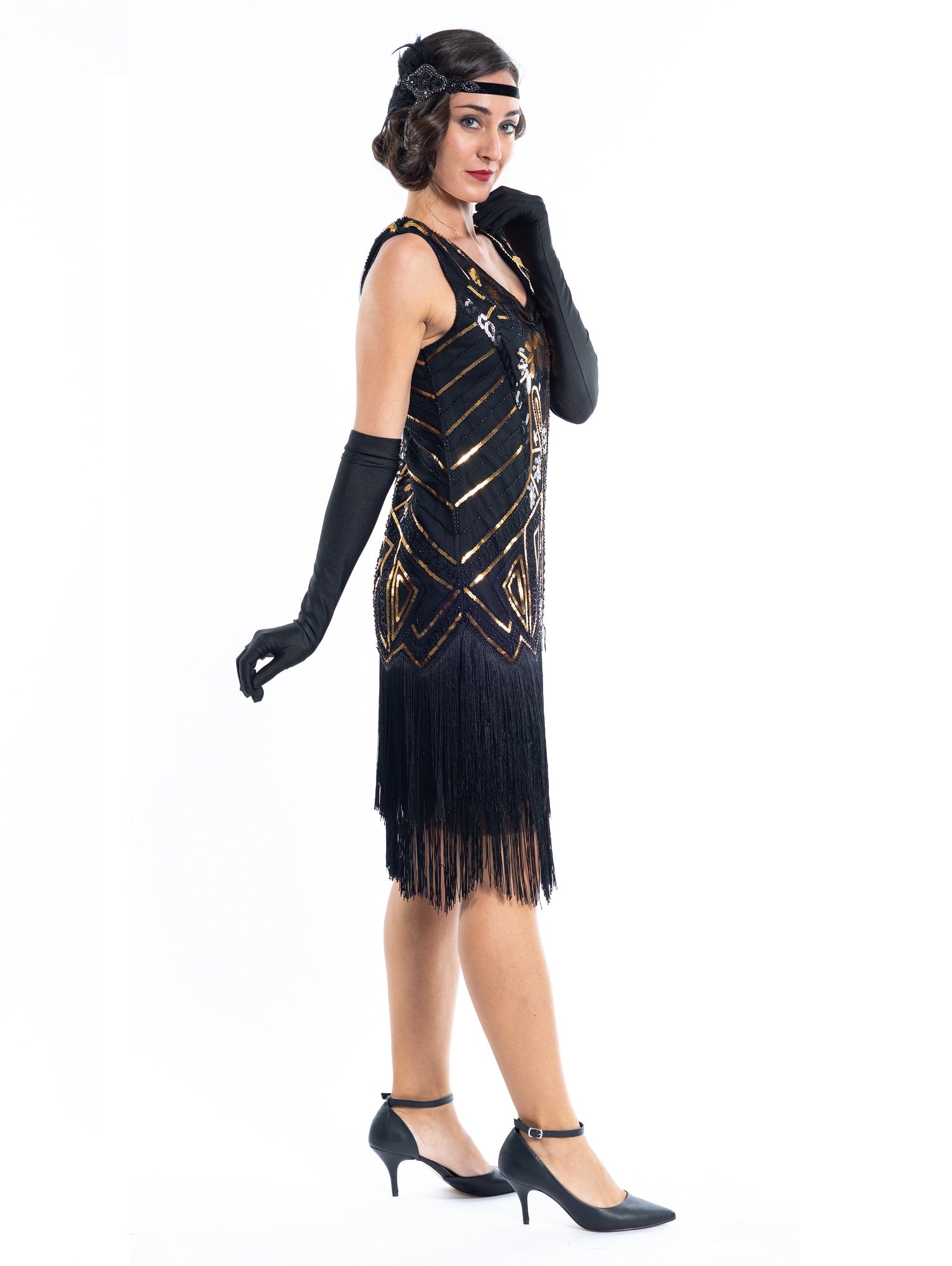 A black flapper dress with gold sequins, beads and black fringes around the hem - Side View