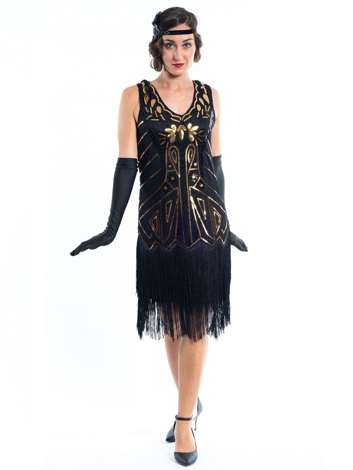 A black flapper dress with gold sequins, beads and black fringes around the hem