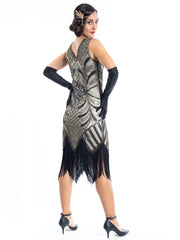 A vintage flapper dress with gold sequins, gold beads and fringes around the hem - Back View