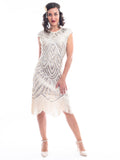 A vintage 1920s flapper dress in ivory white with beads, sequins and fringes around hem.