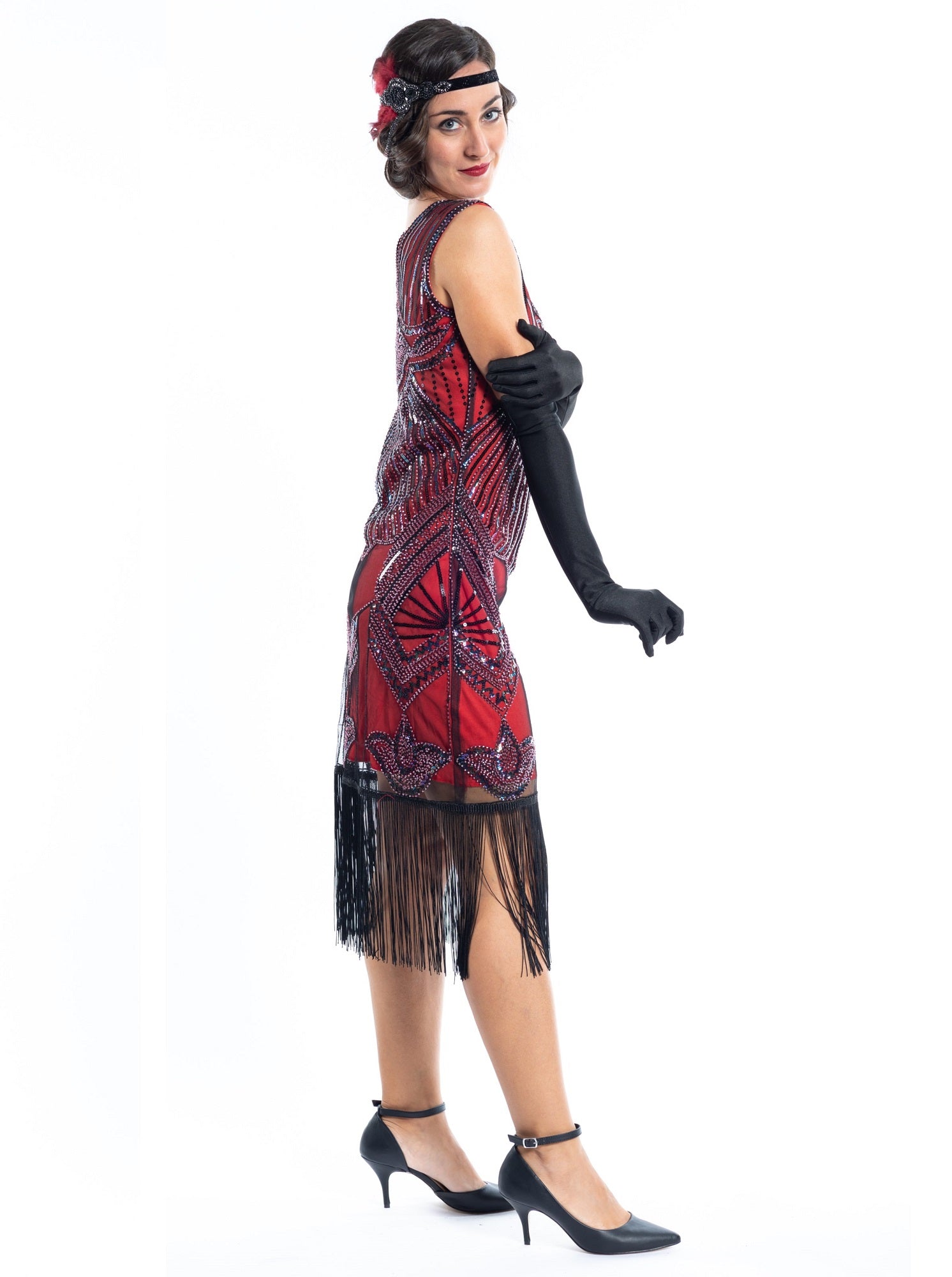 A red flapper dress with a 1920s deco pattern of sequins, beads and fringes around the hem - side view