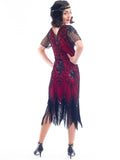 A back view of a burgundy red 1920s Flapper Dress with black beads, sequins, sheer sleeves and black fringes
