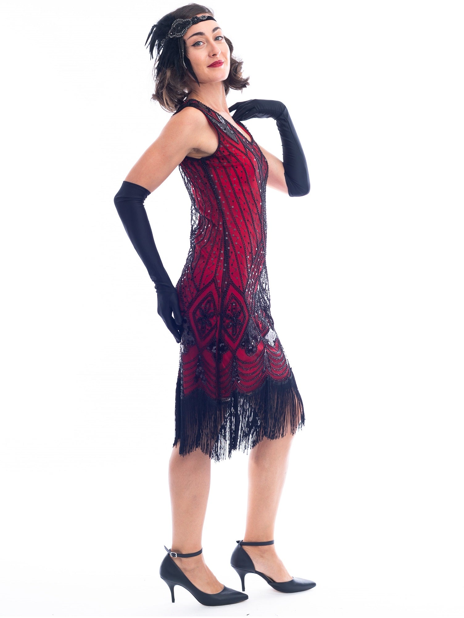 A side view of a Red Gatsby Dress with deco pattern of black sequins and beads. 