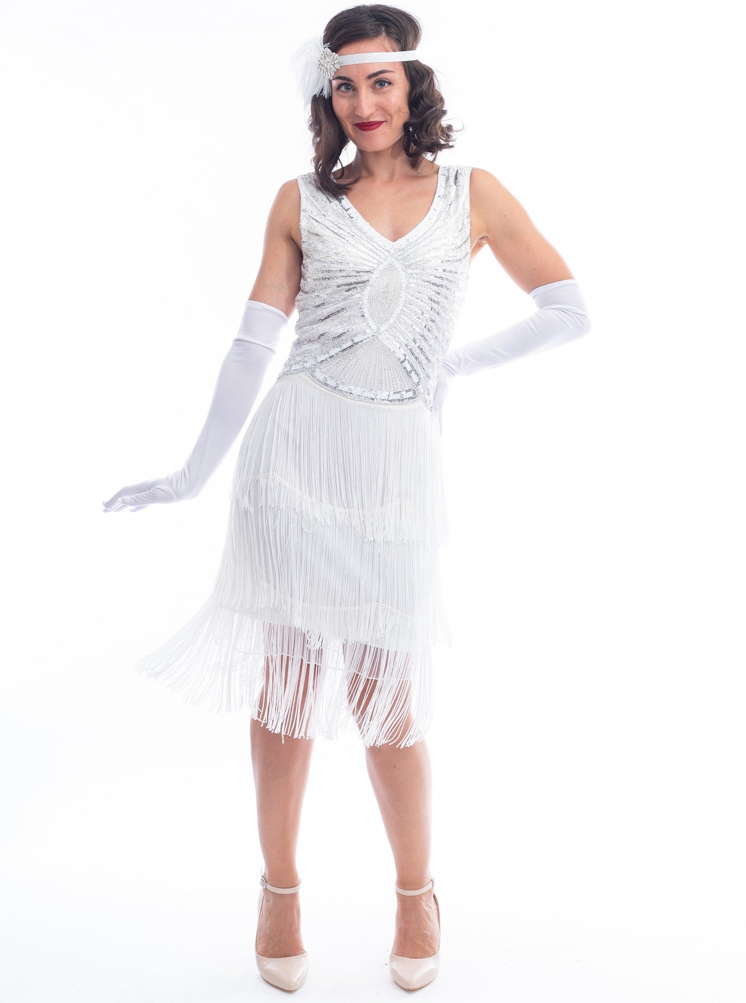 A vintage white gatsby dress with white beads, sequins and fringes around hem.