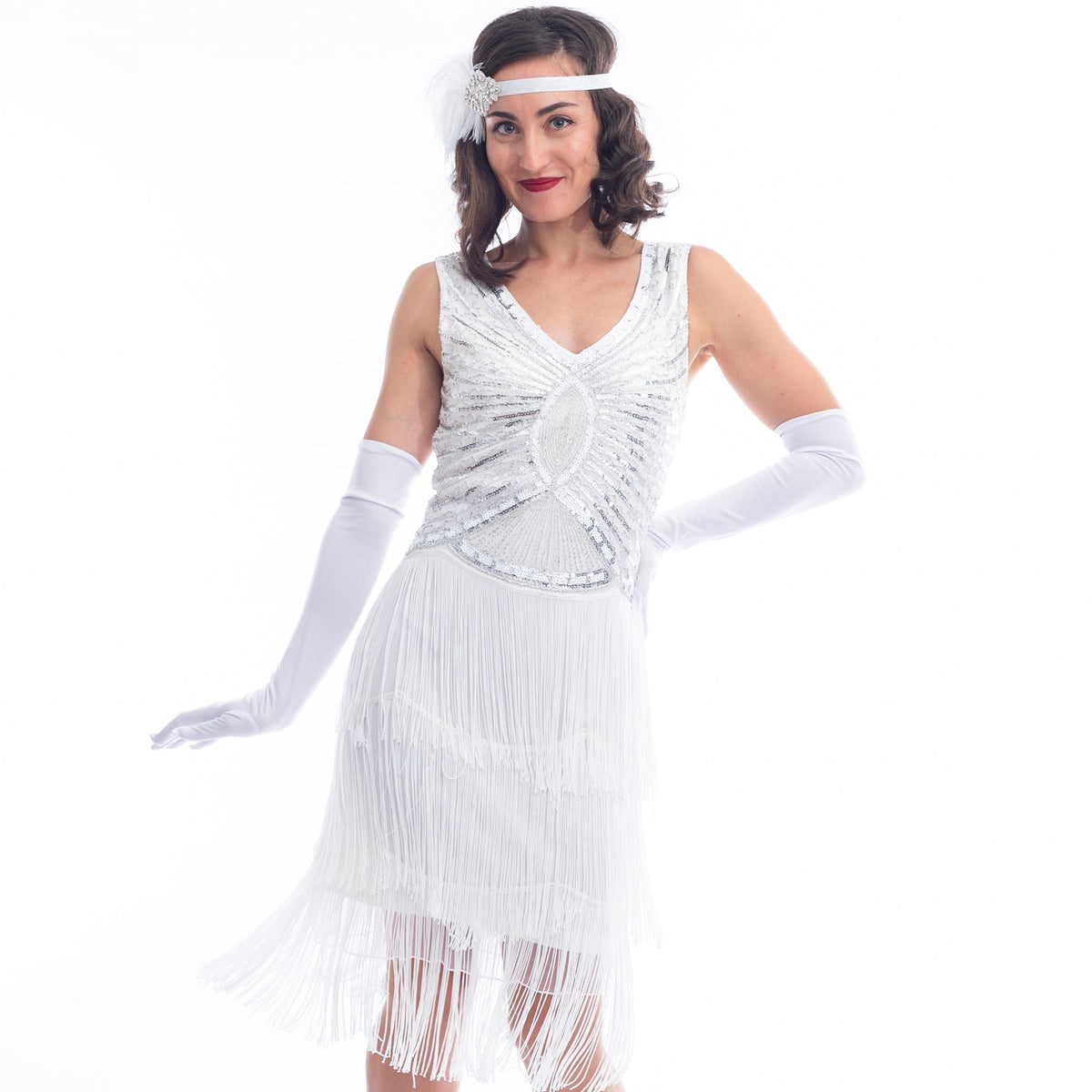 A close view vintage white gatsby dress with white beads, sequins and fringes around hem.